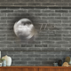 A new QLED TV against a brick wall.